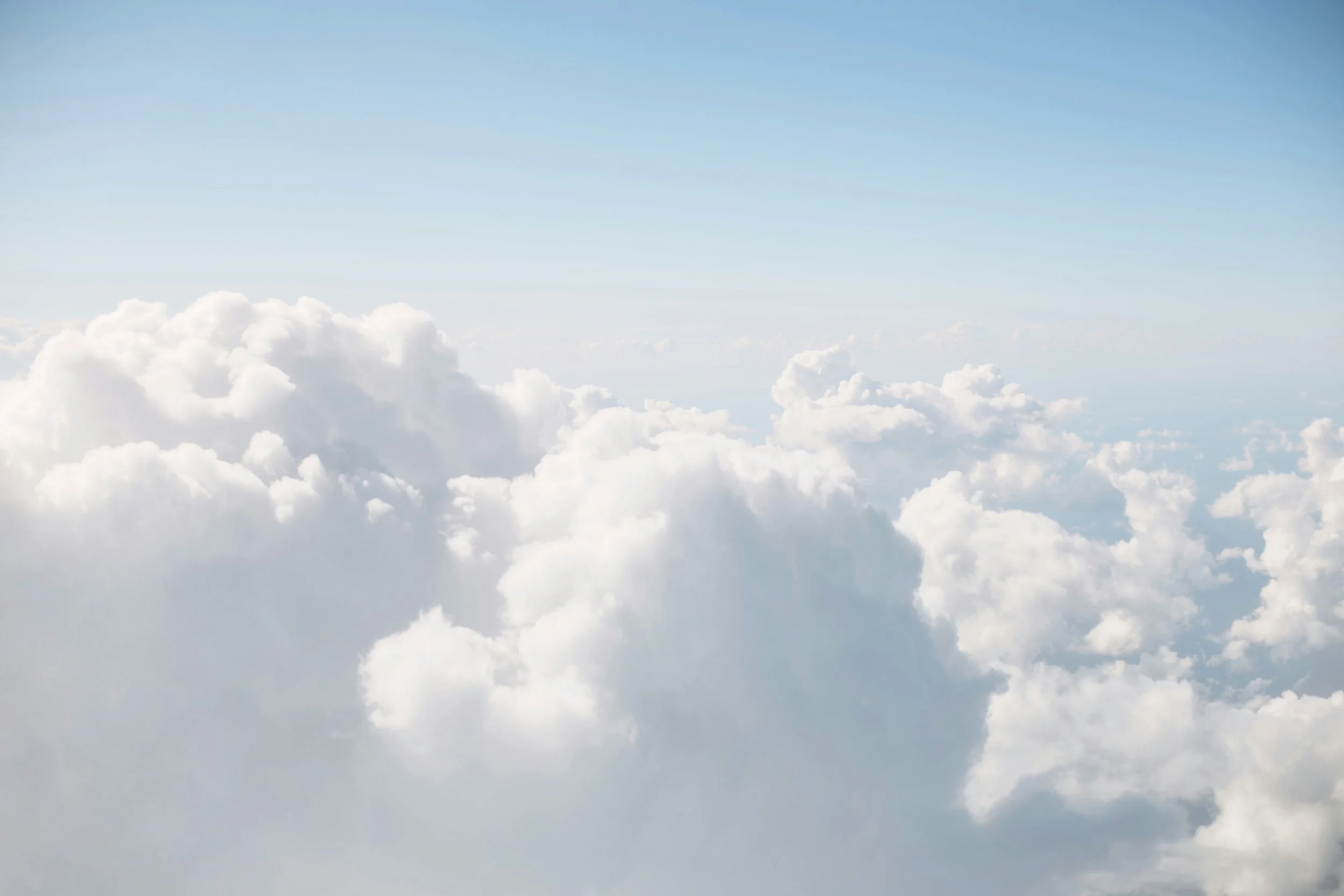 Soft clouds against pale daylight sky